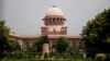 FILE - A gardener works on the lawns of the Supreme Court in New Delhi, Aug. 22, 2017. The court has agreed to hear petitions seeking legal recognition of same-sex marriages, raising hopes of securing another significant right for the country’s LGBTQ community.