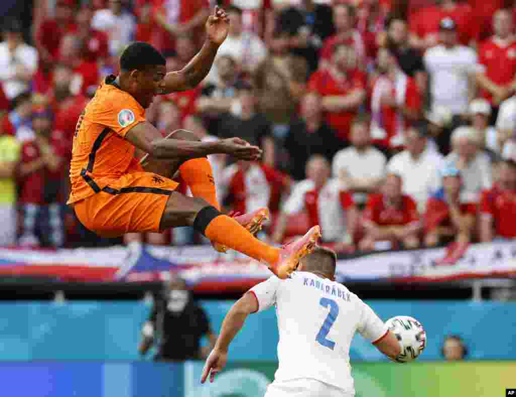 Czech Republic&#39;s Pavel Kaderabek, right, challenges Denzel Dumfries of the Netherlands during the Euro 2020 soccer championship round of 16 match between Netherlands and Czech Republic at the Ferenc Puskas stadium in Budapest, Hungary.