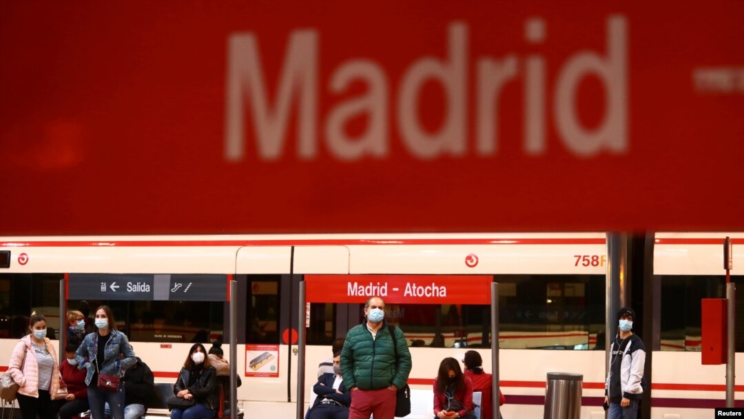 Commuters wearing protective face masks wait on a platform at Atocha train station during a partial lockdown amid the outbreak of the coronavirus disease (COVID-19), in Madrid, Spain, Oct. 5, 2020. 