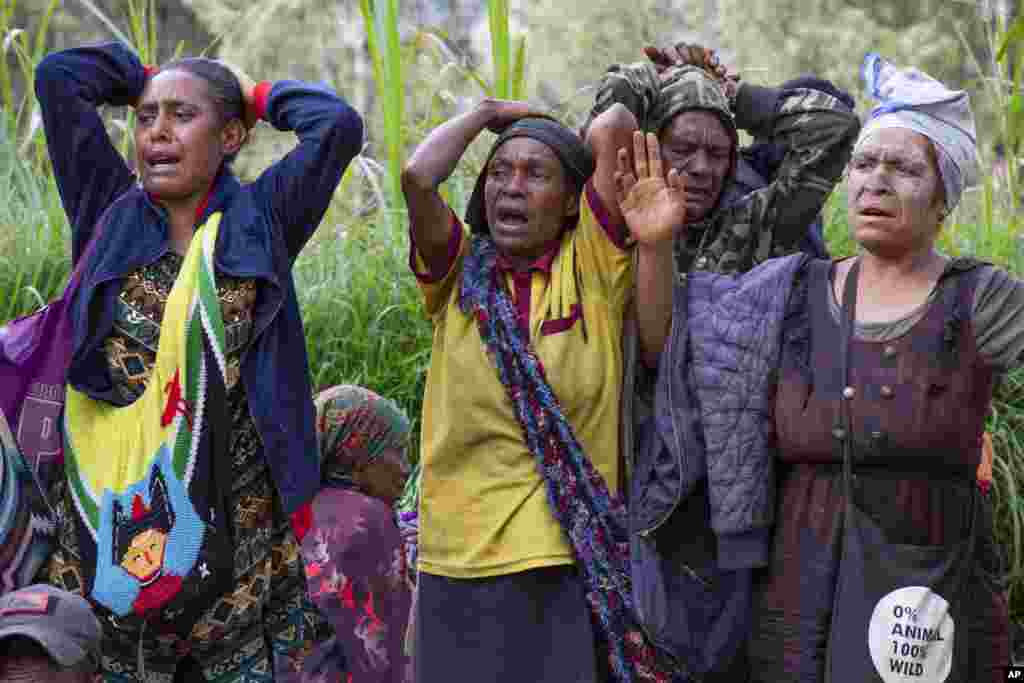 In this photo released by UNDP Papua New Guinea, villagers react as they search through a landslide in Yambali village, in the Highlands, May 27, 2024.&nbsp;Authorities fear a second landslide and a disease outbreak are looming at the scene of Papua New Guinea&#39;s recent mass-casualty disaster because of water streams trapped beneath tons of debris and decaying corpses seeping downhill following the May 24 landslide.