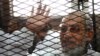 FILE - Egyptian Muslim Brotherhood's general guide , Mohamed Badie at the trial of Brotherhood members in February, 2014 near Cairo's Turah prison.