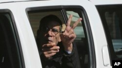 EgyptAir plane hijacking suspect Seif Eddin Mustafa flashes the victory sign as he leaves a EgyptAir plane hijacking suspect Seif Eddin Mustafa flashes the victory sign as he leaves a court in a police car after a remand hearing as authorities investigate him on charges including hijacking, illegal possession of explosives and abduction in the Cypriot coastal town of Larnaca, March 30, 2016. 