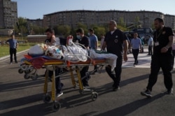 An ethnic Armenian soldier, who was wounded in fighting with Azeri forces over the breakaway region of Nagorno-Karabakh, is carried on a stretcher to Erebouni Medical Center in Yerevan, Armenia, Sept. 29, 2020. (Credit: Hakob Margaryan/Photolure)