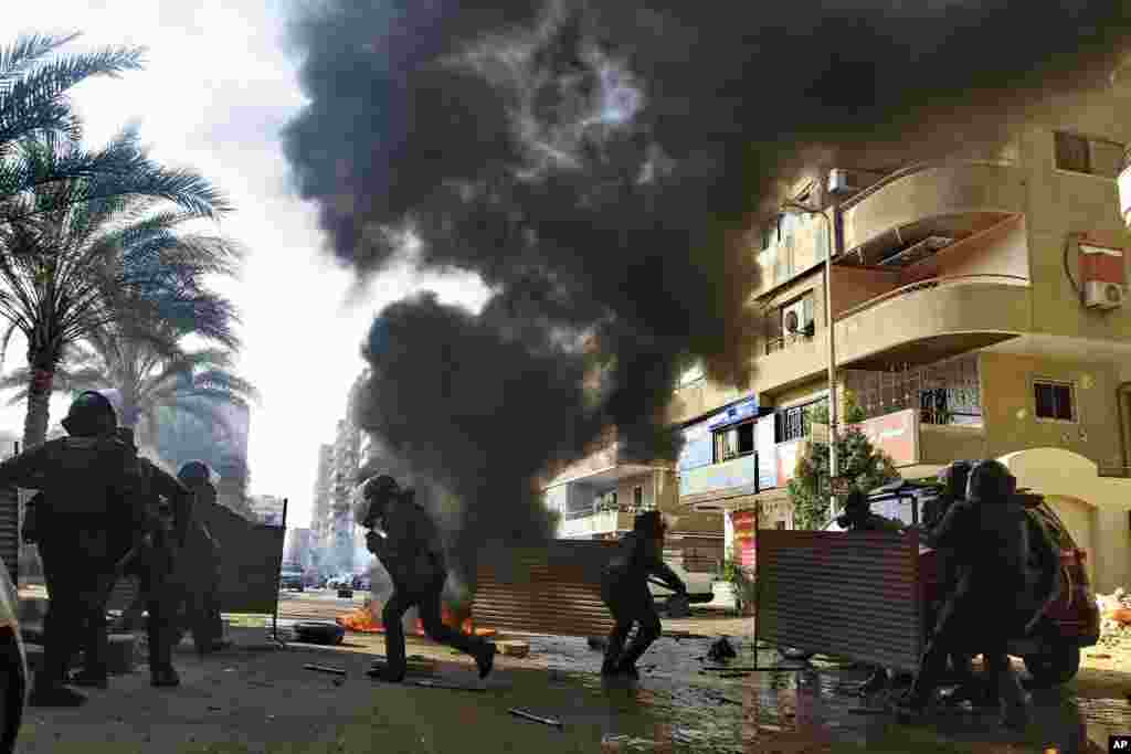 Egyptian security forces clash with supporters of ousted President Mohamed Morsi in the Nasr City district of Cairo. Hundreds of Islamists rallied in Cairo and across the country, calling for a boycott of an upcoming constitutional referendum. 