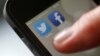 An illustration picture shows a man starting his Twitter App on a mobile device in Hanau near Frankfurt, Oct. 21, 2013. 