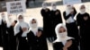 Ethnic Uighur women take part in a protest against China, in Istanbul