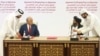 FILE - In this Feb. 29, 2020 file photo, U.S. peace envoy Zalmay Khalilzad, left, and Mullah Abdul Ghani Baradar, the Taliban group's top political leader sign a peace agreement between Taliban and U.S. officials in Doha, Qatar. 