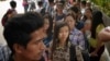 Myanmar citizens wait outside the Myanmar Embassy in Singapore to cast advance ballots on Oct. 18, 2015. 