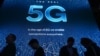 FILE - Attendees wait in line for a 5G exhibition at the Qualcomm booth during CES 2019 consumer electronics show, at the Las Vegas Convention Center in Las Vegas, Jan. 10, 2019.