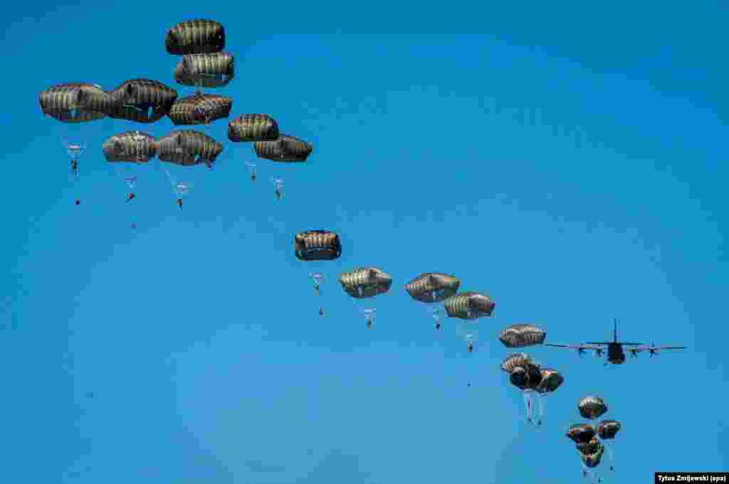 U.S. paratroopers from the 82 Airborne Division and Lockheed C-130 Hercules aircraft are seen during the Swift Response-16 part of the NATO Anaconda-16 exercise near Torun, Poland.