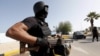 FILE - A member of the force assigned to protect Libya's unity government stands at the entrance to where the government has their offices, in Tripoli, Libya, April 14, 2016.