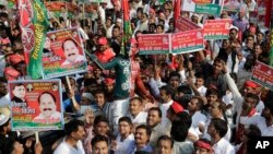 FILE - Samajwadi Party supporters gather for the launch of the party's election campaign for the state of Uttar Pradesh, in Lucknow, India, Nov. 3, 2016.