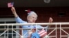 A resident of the Lambeth House, where a cluster of the coronavirus has formed, reacts from her balcony as opera singers Irini Hymel and Bryan Hymel sing to the quarantined residents in New Orleans, March 20, 2020.