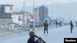 Afghan National Army soldiers keep watch near the site of a blast in Jalalabad, Afghanistan, Feb. 11, 2021. An attack Thursday on a United Nations convoy in Afghanistan killed at least five members of the local security force escorting it.