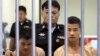Myanmar migrants Win Zaw Htun, right, and Zaw Lin, left, both 22, are escorted by officials after their guilty verdict at court in Koh Samui, Thailand, Thursday, Dec. 24, 2015.