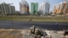 Laborers work at the construction site of a residential complex on the outskirts of Kolkata, India, Jan. 29, 2018. 