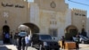 In this June 21, 2021 file photo, Bassem Awadallah, a former royal adviser, leaves a state security court in a vehicle after the first session of his closed-door trial, in Amman, Jordan. 