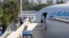 Passengers from virus-stricken cruise ships begin to depart