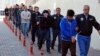 Police officers escort people, arrested because of suspected links to U.S.-based cleric Fethullah Gulen, in Kayseri, Turkey, April 26, 2017.