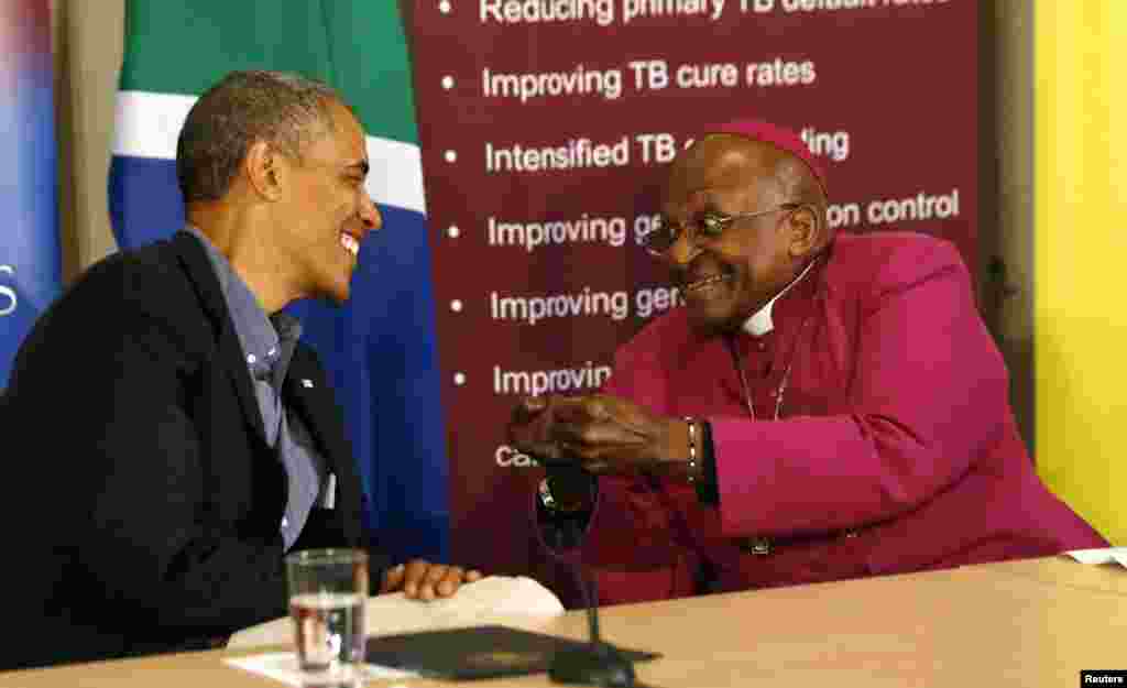 U.S. President Barack Obama listens to Desmond Tutu as he visits his HIV Foundation Youth Center and takes part in a health event in Cape Town, June 30, 2013.