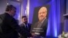FILE - Mongi Dhaouadi (L) and Ahmed Bedier set up an image of slain Saudi journalist Jamal Khashoggi before an event to remember Khashoggi, a columnist for The Washington Post who was killed inside the Saudi Consulate in Istanbul on Oct. 2, in Washington, Nov. 2, 2018.