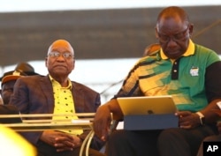 Newly-elected ruling African National Congress (ANC) party president, Cyril Ramaphosa, right, and former ANC president and South African President Jacob Zuma, left, attend the party's 106th birthday celebrations in East London, South Africa, Jan. 13, 2018