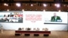 FILE - U.S. Secretary of State Mike Pompeo, projected onto background screen right, speaks as peace talks between the Afghan government and Taliban insurgents get underway in Doha, Qatar, Sept. 12, 2020.