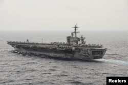 FILE - The aircraft carrier USS Theodore Roosevelt (CVN 71) transits the South China Sea in this U.S. Navy picture taken Oct. 29, 2015. U.S. Secretary of Defense Ash Carter visited the Roosevelt as it transited the South China Sea last week.