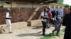 Security officers patrol the Kano State Polytechnic campus in northern Nigeria, where a female suicide bomber blew herself up, July 30, 2014.
