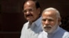 Indian PM Narendra Modi, right, talks to media upon his arrival at the parliament house as Venkaiah Naidu stands along in New Delhi, India, April 25, 2016.