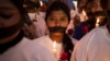 FILE - Indian women participate in a candle light vigil at a bus stop where the victim of a 2012 deadly gang rape had boarded the bus on what would become her final journey, in New Delhi, India, Dec. 16, 2014.