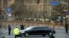 Petugas keamanan bersiaga penuh saat limusin Mercedes dalam iring-iringan yang diyakini membawa pemimpin Korea Utara Kim Jong-un melewati jalan di Beijing, Rabu, Januari 9, 2019.