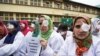 Kashmiri doctors and medical workers wear bandages on their eyes as a mark of protest against the use of pellet guns and recent killings in Srinagar, Indian-controlled Kashmir, Wednesday, Aug. 10, 2016. 