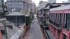 FILE - The normally bustling tourist mecca of Bourbon Street lies deserted in the early afternoon during shelter in place orders to slow the spread of the coronavirus, in New Orleans, Louisiana, March 27, 2020.