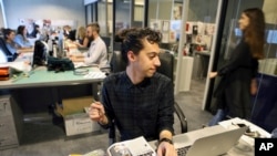 Mohammad Hazem Rezq, one of the Vogue staff works behind his desk at the magazine office at the Dubai Design District in Dubai, United Arab Emirates, Wednesday, March 15, 2017. 