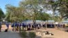 Pupils at a private school in Harare queue for temperature checks before they starts lessons, Nov. 11, 2020. (Columbus Mavhunga/VOA)