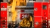 A firefighter leans against his fire truck while resting from working on a wildfire in Los Angeles, Monday, Oct. 28, 2019.
