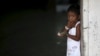 A young Rohingya migrant who arrived in Indonesia last week by boat eats a snack at a temporary shelter in Aceh Timur regency near Langsa in Indonesia's Aceh Province, May 26, 2015. 