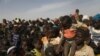 FILE - Displaced children wait for help at a village of Dablo area, Burkina Faso, March 2, 2019. 