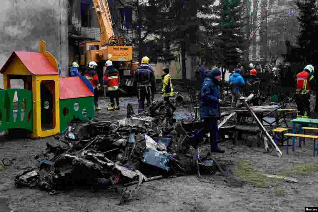 Emergency personnel work at the site of a helicopter crash in the town of Brovary, outside Kyiv, Ukraine.&nbsp;A helicopter crashed into a nursery and set it ablaze in a suburb of the capital. killing at least 14 people, including Interior Minister Denys Monastyrskyi.