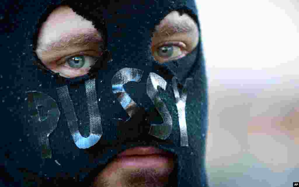 A masked man attends a Pussy Riot support rally in Sydney.