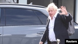 Former British Prime Minister Boris Johnson walks, at Gatwick Airport, near London, Britain, Oct. 22, 2022. 