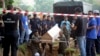 FILE - Malaysian officials provide Muslim burials to 21 human trafficking victims, believed to be Rohingya refugees, found in shallow graves in jungles bordering Thailand, in Kedah, Malaysia, June 22, 2015.