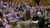 Britain's Prime Minister Boris Johnson delivers a statement to lawmakers inside a crowded House of Commons in London, Oct. 19, 2019. At a rare weekend session, Johnson implored legislators to ratify a last-minute Brexit deal he struck with EU leaders.