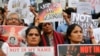 Participants hold placards during a protest against a spate of violent attacks across the country targeting the country's Muslim minority, in Bangalore, India, June 28, 2017. 