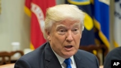 President Donald Trump speaks during his meeting with automobile leaders in the Roosevelt Room of the White House in Washington, Jan. 24, 2017.