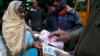 Traders transact at a wholesale vegetable market in Bangalore, India, Dec. 30, 2016. India yanked most of its currency bills from circulation without warning, delivering a jolt to the country's high-performing economy.