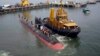 The INS Kalvari, one of the six Scorpene diesel-electric attack submarines, is set afloat at the naval dockyard in Mumbai, India, Thursday, Oct. 29, 2015. 