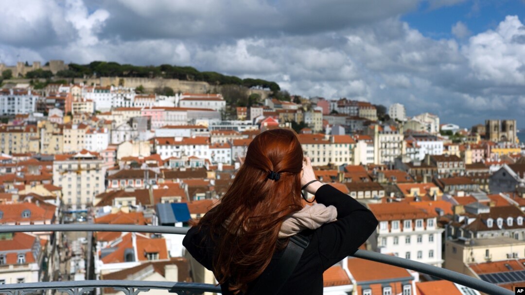A woman takes pictures from the top of Lisbon's Santa Justa lift, April 19 2016.