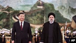 资料图：中国与伊朗领导人在北京会晤。